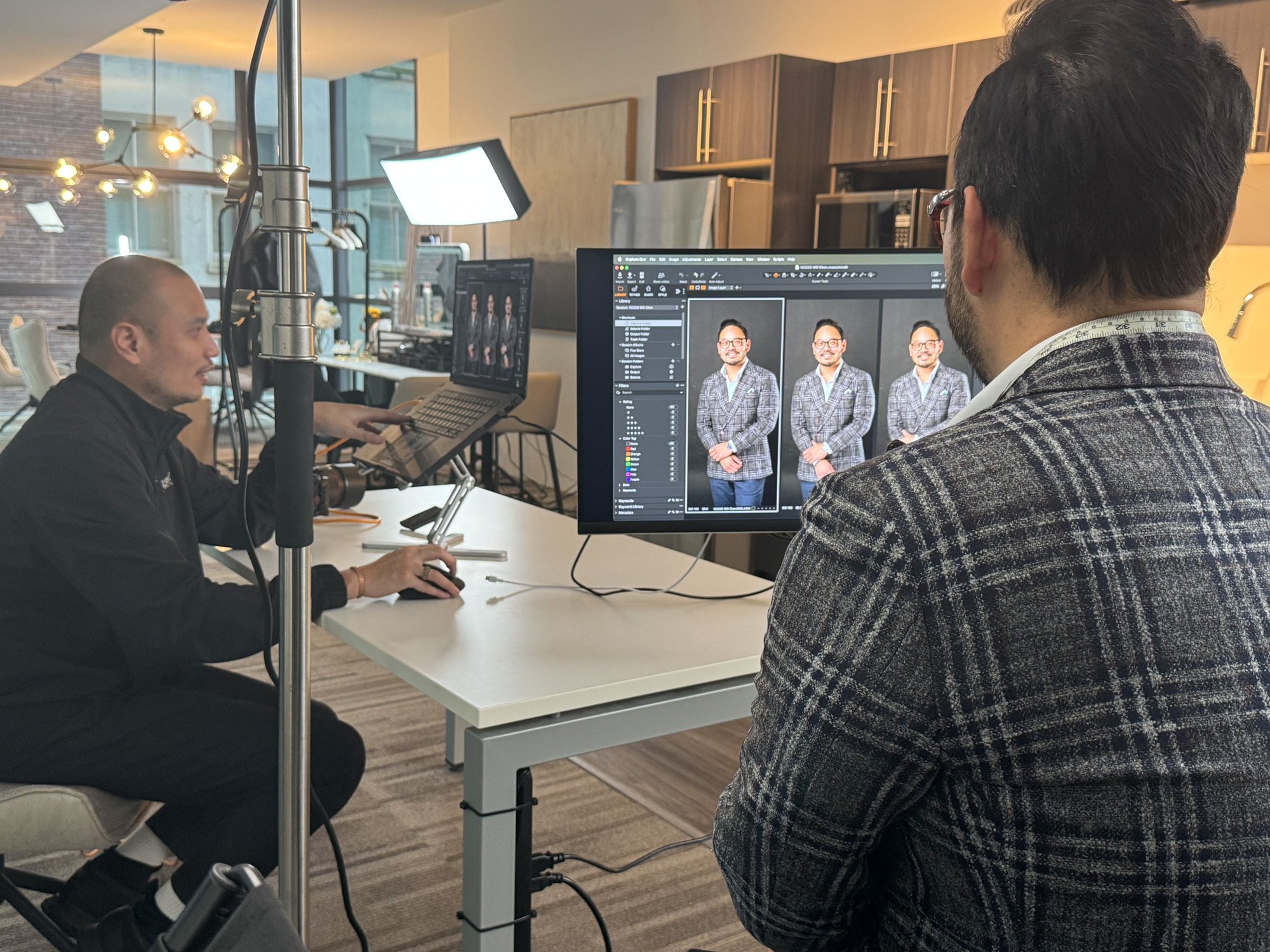 A Headshot Photo session: the photographer and client review each frame full-size on a monitor